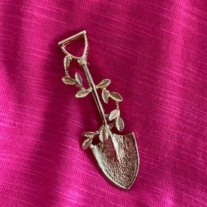 Vintage shovel and leaves in golden tone